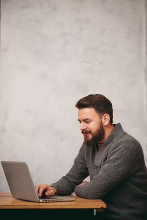 Man using laptop for work and sitting in cafeの写真素材