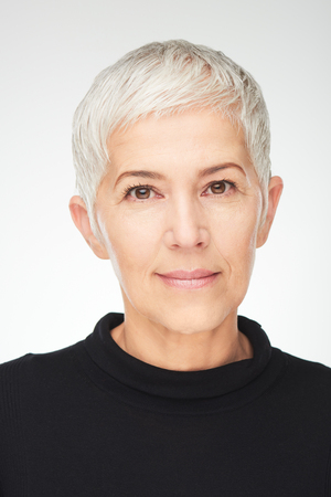 Portrait of beautiful senior woman in front of white background.の写真素材