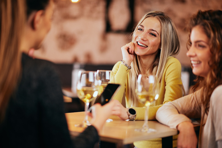 Yung woman sitting in cafe and drinking coffee.の写真素材