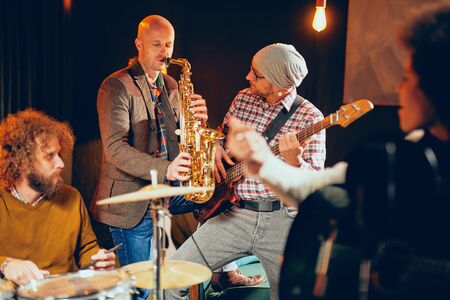 Multicultural jazz band practicing for the gig in home studio.