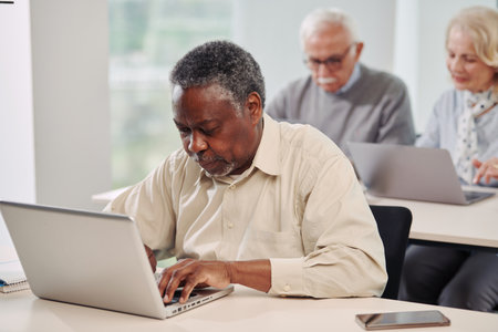 Senior students working on project on laptop in classroom.の写真素材