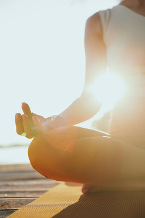 Close-up of a yogi woman sitting in a lotus pose and meditating.の写真素材