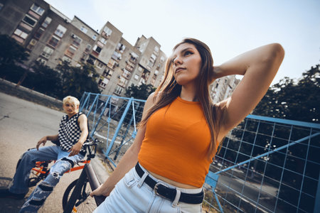 Teenagers are chilling outside in the urban exterior.の写真素材