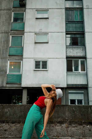 A teenage girl is looking over her shoulder at the urban exterior.の写真素材