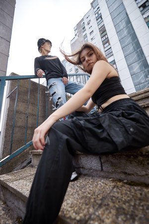A teenage couple posing on the street. Selective focus on the teenage boy.