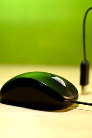 Computer mouse and its usb cable placed on a wooden base home useの写真素材
