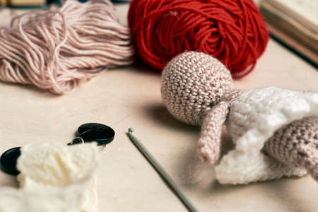yarn doll made with needles to weave yarn, around it yarn of various colorsの写真素材