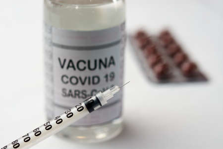 Bottle with vaccine for covid-19 SARS-CoV-2 together with two syringesの写真素材