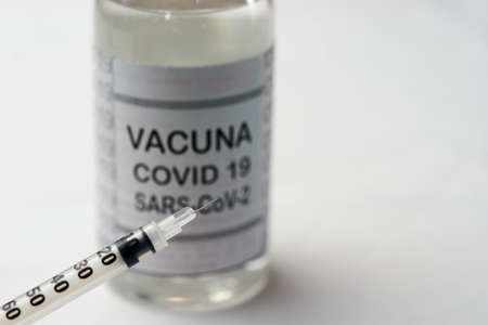 Bottle with vaccine for covid-19 SARS-CoV-2 together with two syringesの写真素材