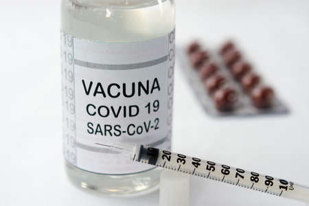 Bottle with vaccine for covid-19 SARS-CoV-2 together with two syringesの写真素材