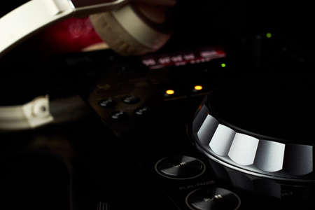 compact disc jockey player with a microphone, in the background a professional headphonesの写真素材