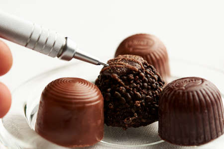 Multi-textruas chocolate, placed in a simple glass plate