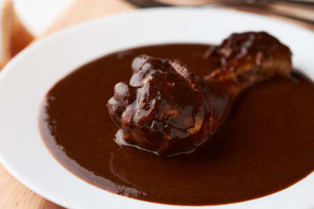 Chicken with mole, Mexican tradition, placed on woodの写真素材