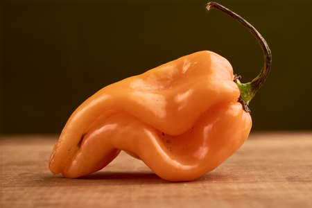 Yellow habanero chili placed on a wooden baseの写真素材