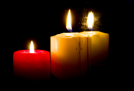 burning candles in the dark image can be used on various themed holidaysの写真素材