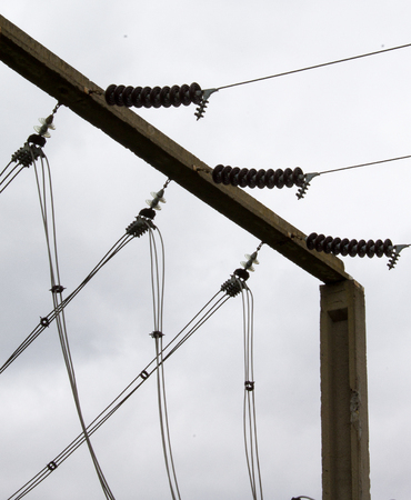 high-voltage wires on a background of gray skyの写真素材