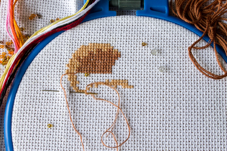 cross stitch,beads on fabric, hand made backgroundの写真素材