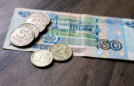 the Russian currency, the Russian money, rubles and coins on a wooden backgroundの写真素材