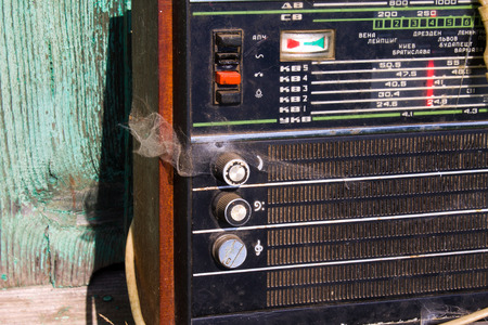Close up of an old radio.The old radio receiver with a webの写真素材