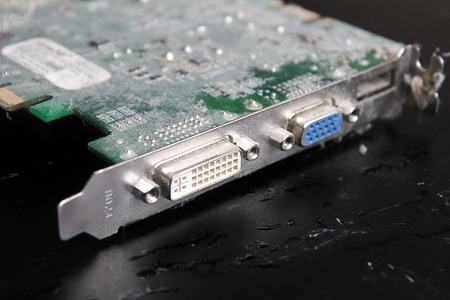 the computer video card in dust, usb close up, against a dark background, a boardの写真素材