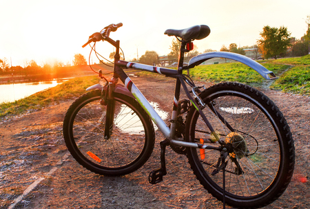 Morning cycling. Sunrise fitness by bicycle.Mountain biking on the field roadの写真素材