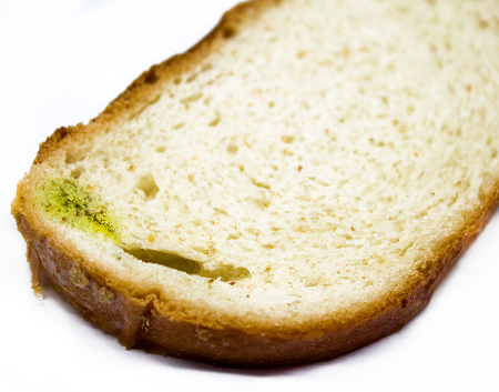 Stale white loaf, is isolated, for a background.Fungus on bread close-up shot,Food safety concept.の写真素材