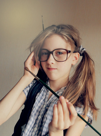 Cute little girl writing her homework at the table, close upの写真素材