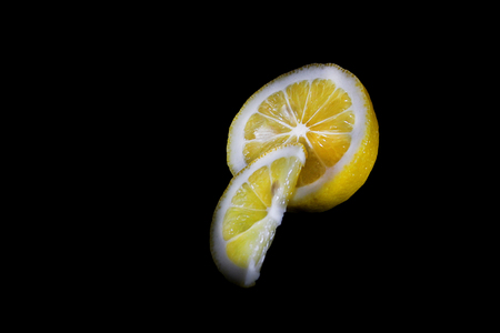 Fresh juicy lemon on a black background,close up.の写真素材