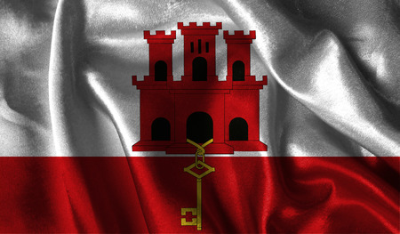 Realistic flag of Gibraltar on the wavy surface of fabric.の写真素材