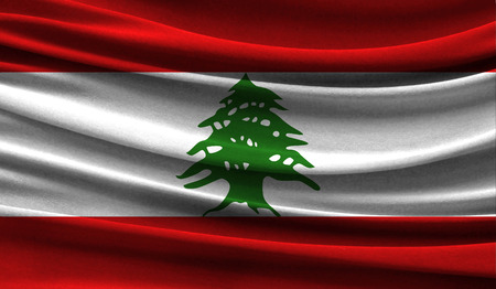 Realistic flag of Lebanon on the wavy surface of fabric. This flag can be used in designの写真素材