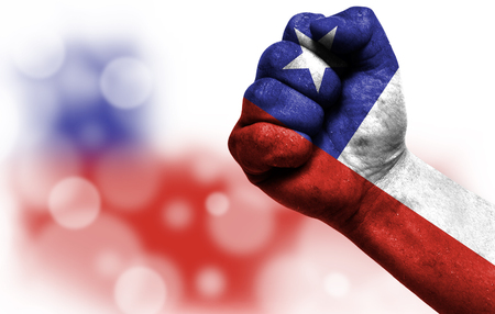Flag of Chile painted on male fist, strength,power,concept of conflict. On a blurred background with a good place for your text.の写真素材