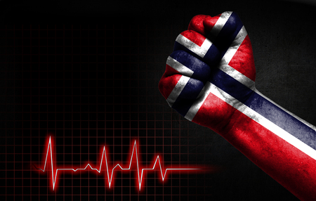 Flag of Norway painted on male fist, the concept image shows the strength of medicine or politics in countries, photography has a good place for your text.の写真素材