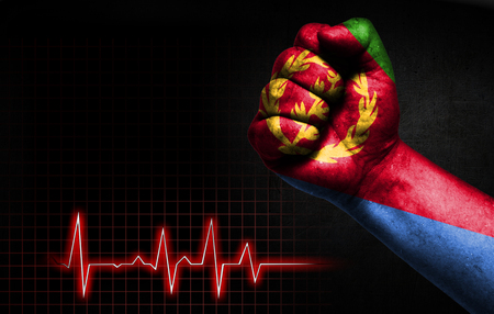 Flag of Eritrea painted on male fist, the concept image shows the strength of medicine or politics in countries, photography has a good place for your text.の写真素材