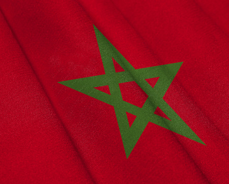 Realistic flag of Morocco on the wavy surface of fabric. This flag can be used in designの写真素材