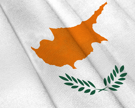 Realistic flag of Cyprus on the wavy surface of fabric. This flag can be used in designの写真素材
