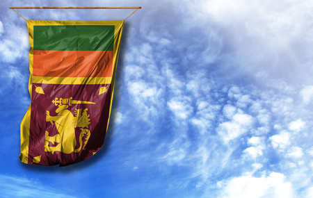 Flag of Sri Lanka. Vertical flag, against blue sky with place for your textの写真素材