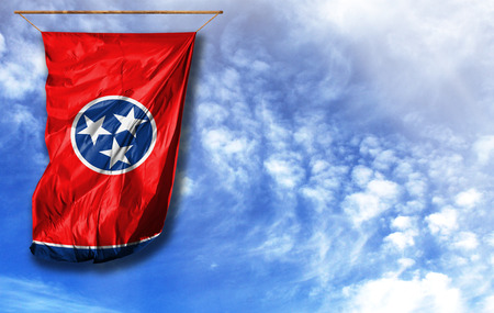 Flag State of Tennessee. Vertical flag, against blue sky with place for your textの写真素材