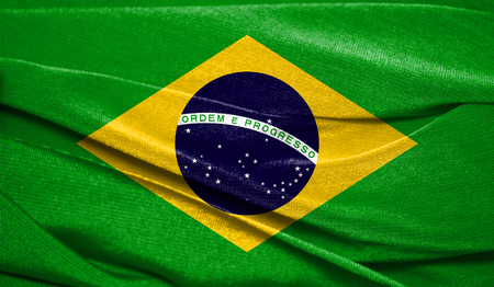 Realistic flag of Brazil on the wavy surface of fabric. Perfect for background or texture purposes.の写真素材