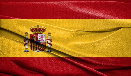 Realistic flag of Spain on the wavy surface of fabric. Perfect for background or texture purposes.の写真素材
