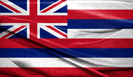 Realistic flag State of Hawaii on the wavy surface of fabric. Perfect for background or texture purposes.の写真素材
