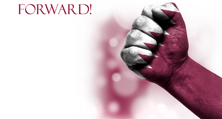 Flag of Qatar painted on male fist on white background with space for your textの写真素材