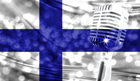 Microphone on a background of a blurry Finland flag close-upの写真素材