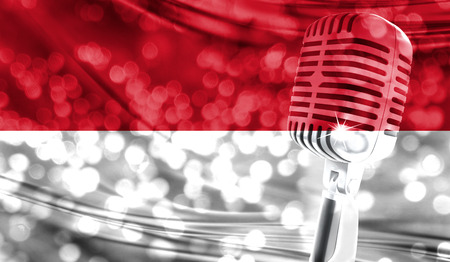 Microphone on a background of a blurry Indonesia flag close-upの写真素材
