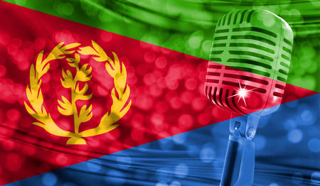 Microphone on a background of a blurry Eritrea flag close-upの写真素材