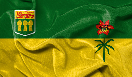 Realistic flag of Saskatchewan on the wavy surface of fabricの写真素材