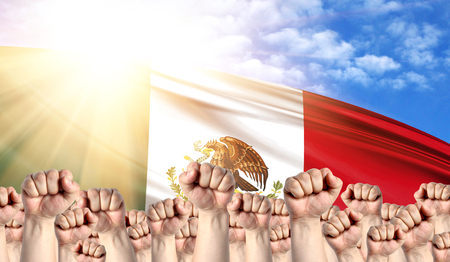 Labor Day concept with fists of men against the background of the flag of Mexicoの素材 [FY310121352877]