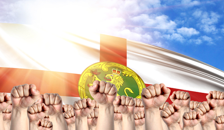 Labor Day concept with fists of men against the background of the flag of Alderneyの写真素材