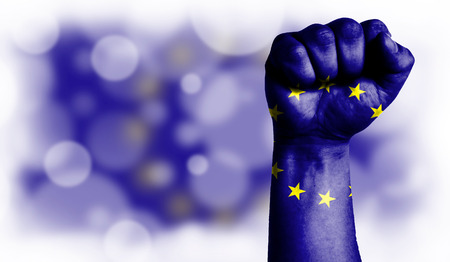 Flag of European Union painted on male fist, strength,power,concept of conflict. On a blurred background with a good place for your text.の写真素材