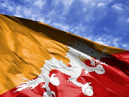 waving flag of Butane close up against blue skyの写真素材
