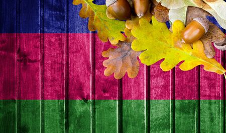 Kuban peoples republic flag on autumn wooden background with leaves and good place for your text.の写真素材
